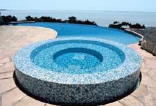 The Canvas:A hidden pool, a hillside home on stilts, a desire to be visibleThe Palette: Perimeter-overflow spa, flagstone deck, rhapsody in blueThe Masterpiece: A radiused curve so graceful it breaks your heart and mends it again in a single second, inspired indulgence, tropical-tinged luxury