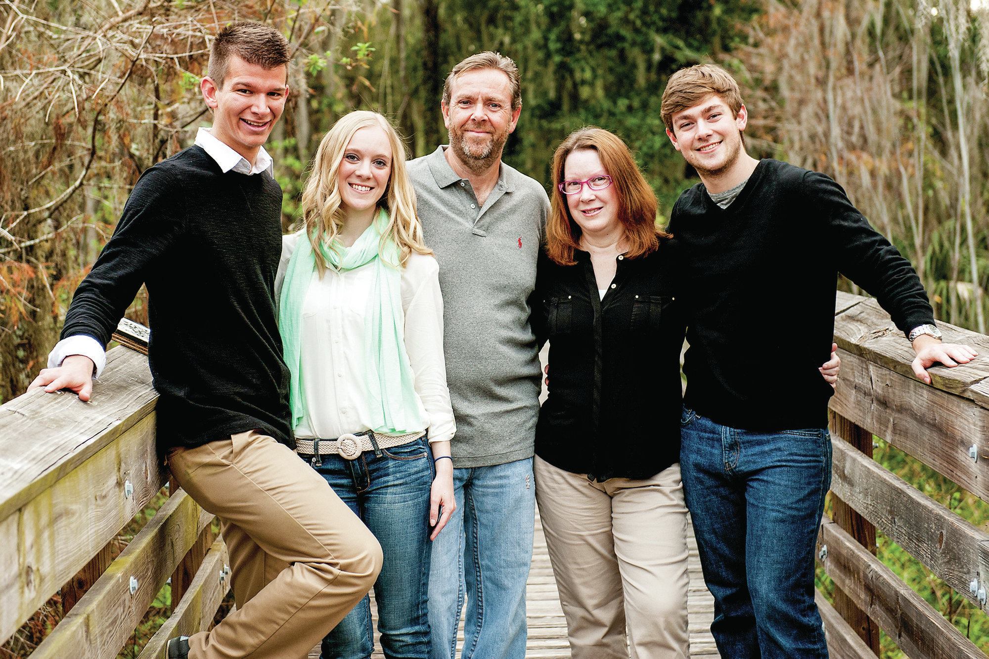 Seeking citizenship: Steve and Zoe Adams are among the thousands of foreigners living in the United States with E-2 Treaty Investor Visas. The couple owns Richards Pool Service in Florida. Pictured above is their son Tom (far right), Zoe, Steve, daughter Melissa and her husband, Jordan, (far left).