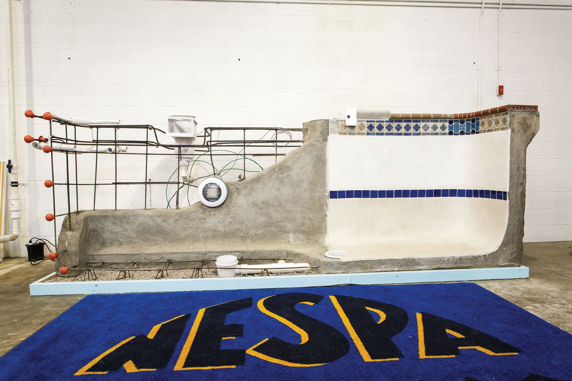 Building a well-educated work force: NESPA’s new hands-on concrete pool display, built by Anthony & Sylvan Pools, will familiarize students with components such as rebar, drains, plumbing, tiles, surfaces, coping and more