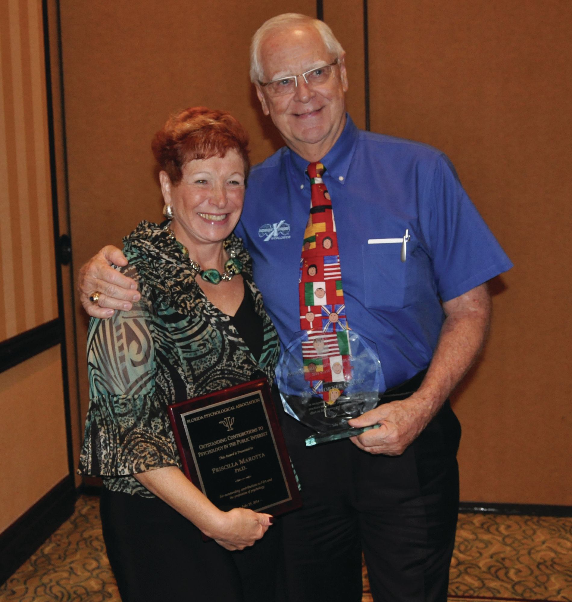 Congrats: Dr. Priscilla Marotta of the Florida Psychological Association presents Team Horner President Bill Kent with a Psychologically Healthy Workplace award.