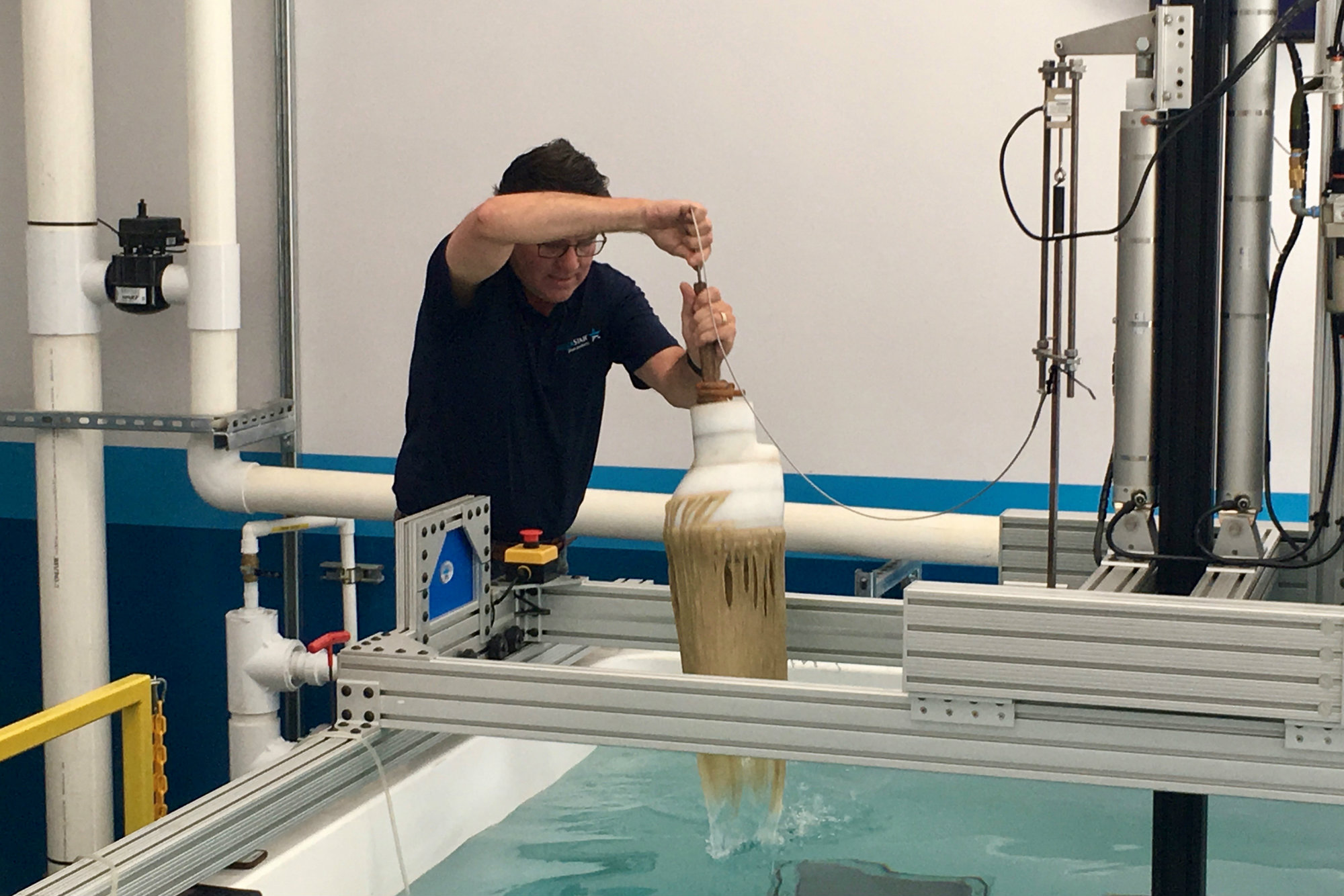AquaStar Pool Products’ director of science and compliance, Steve Barnes, uses the apparatus for testing drain covers for hair-entanglement hazards.