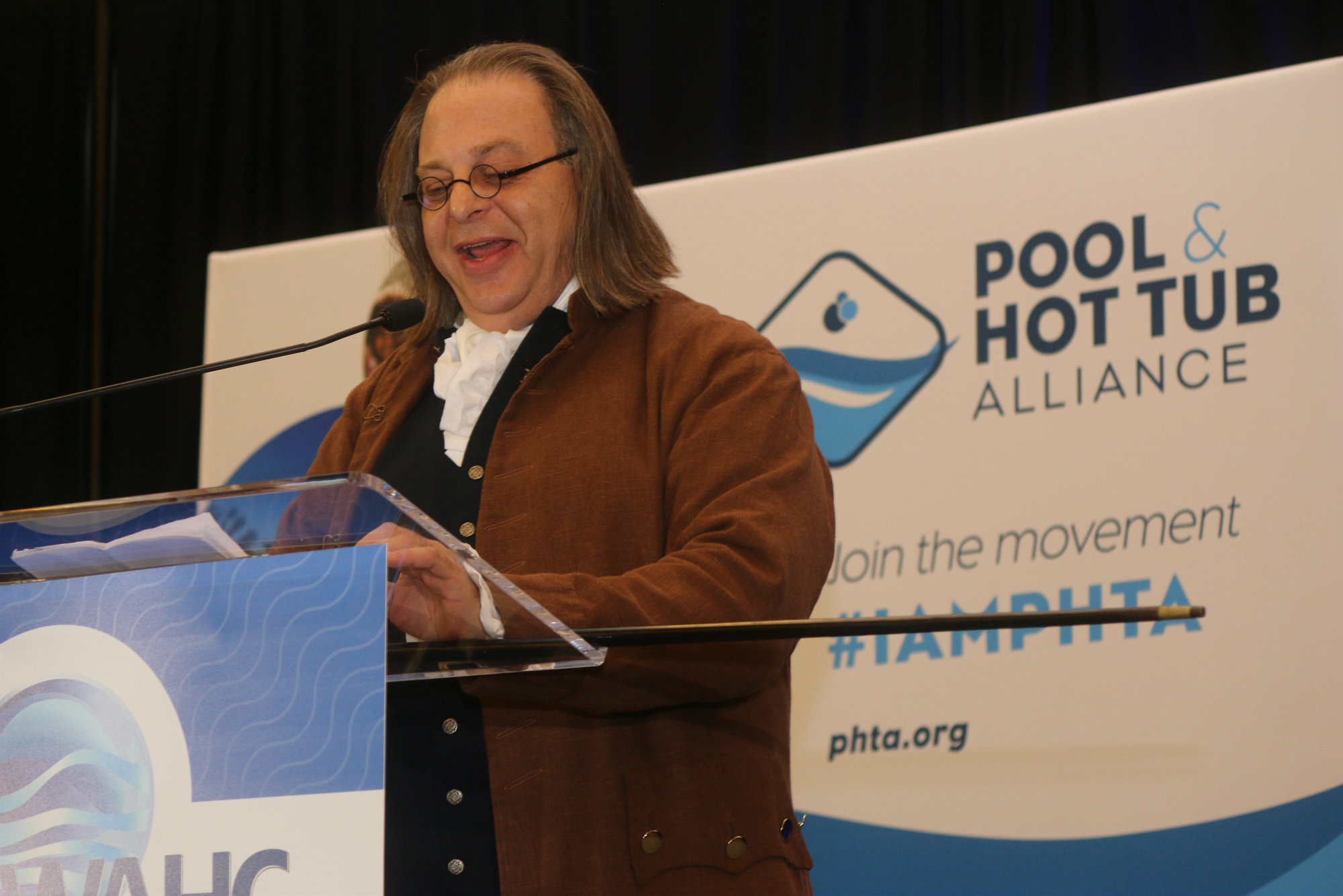 Keynote speaker “Ben Franklin,” explains his fascination and experimentation with swimming to attendees.