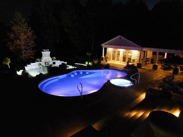 Johnson Pools & Spas of Owego, NY brought a simple L-shaped pool up to date with a free-form vessel featuring luxurious amenities such as bar stools and a radius bench.