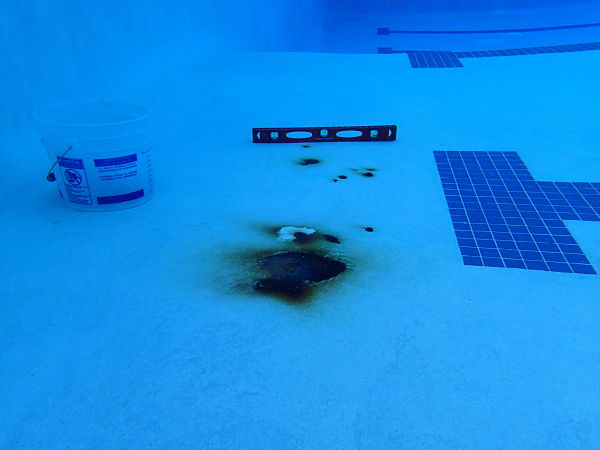 Before: A municipal pool undergoes a rebar repair operation. The rust
 stain shown in the top photo only hints at the extent of damage under 
the shell.