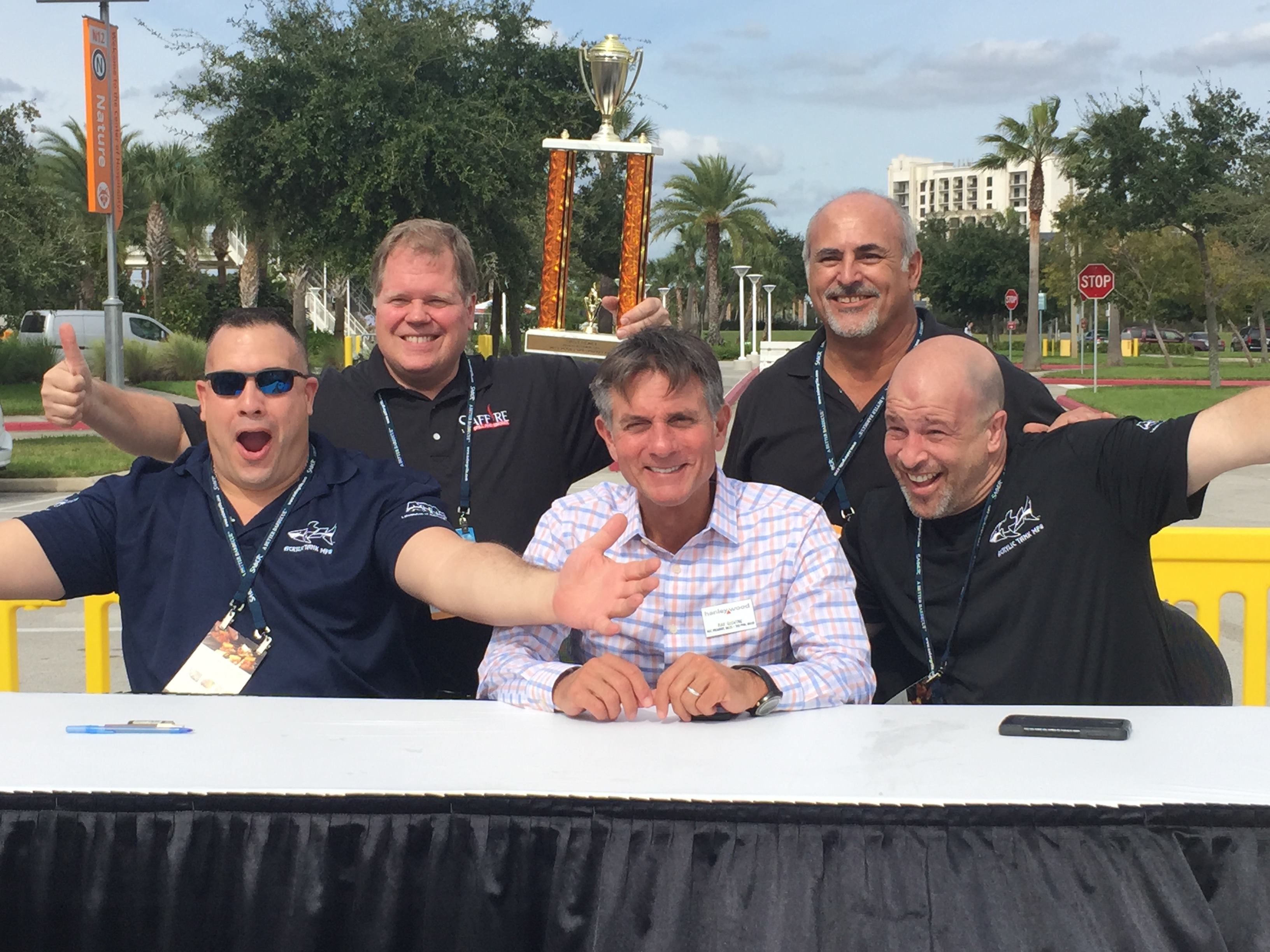 11. The Best BBQ Representatives from Saffire Grill (back row) were elated to collect their trophy for culinary excellence at the fun and tasty BBQ Cookoff. The judging panel included the hosts of Animal Planet's reality television show "Tanked," Wayde King and Brett Raymer (left and right, front row) and Ray Giovine, vice president, sales, 
Pool & Spa News (center, front row).