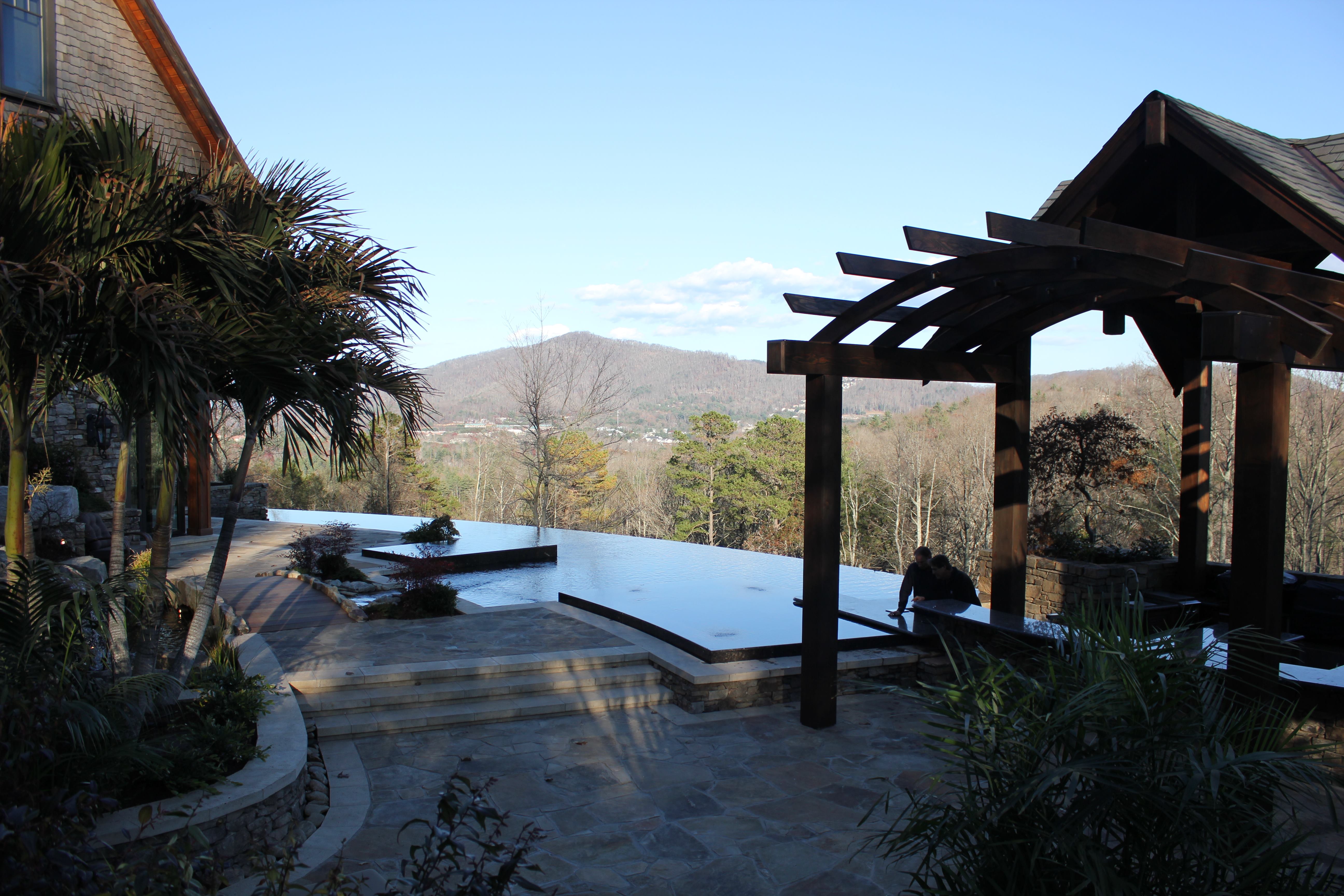 Oftentimes, outdoor kitchens are integrated into the poolscape, so the chef can easily chat with others in the backyard. In this case, however, Dorsey wanted the opposite. The wealthy homeowners generally don’t do their own cooking, but have a staff that prepares meals for them. “So it becomes more like a commercial application, where you have, say, a swim-up bar at a resort,” Dorsey explains. The kitchen features a sunken floor, allowing guests to see over the bartender and enjoy the hillside view.