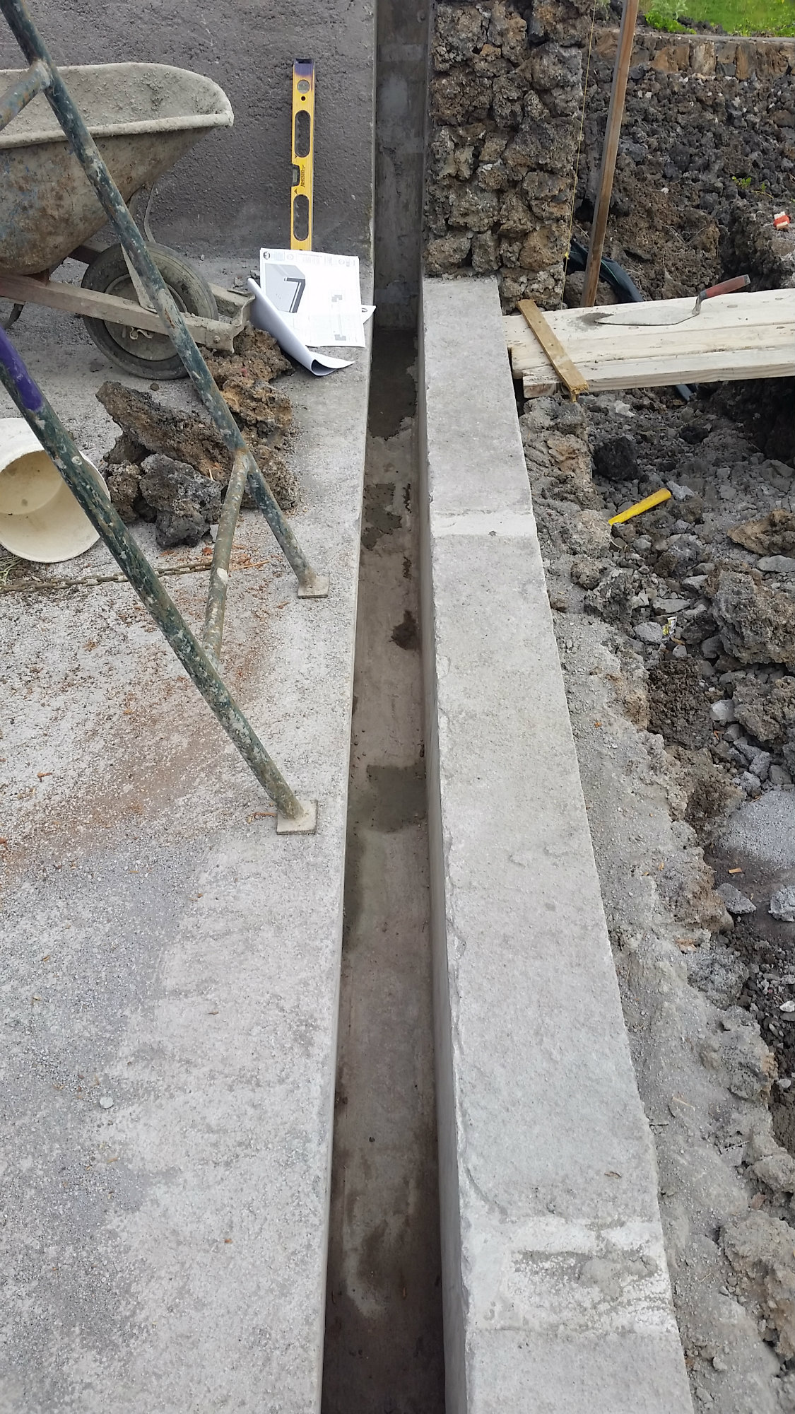 Acrylic vanishing-edge walls are place in a slot.