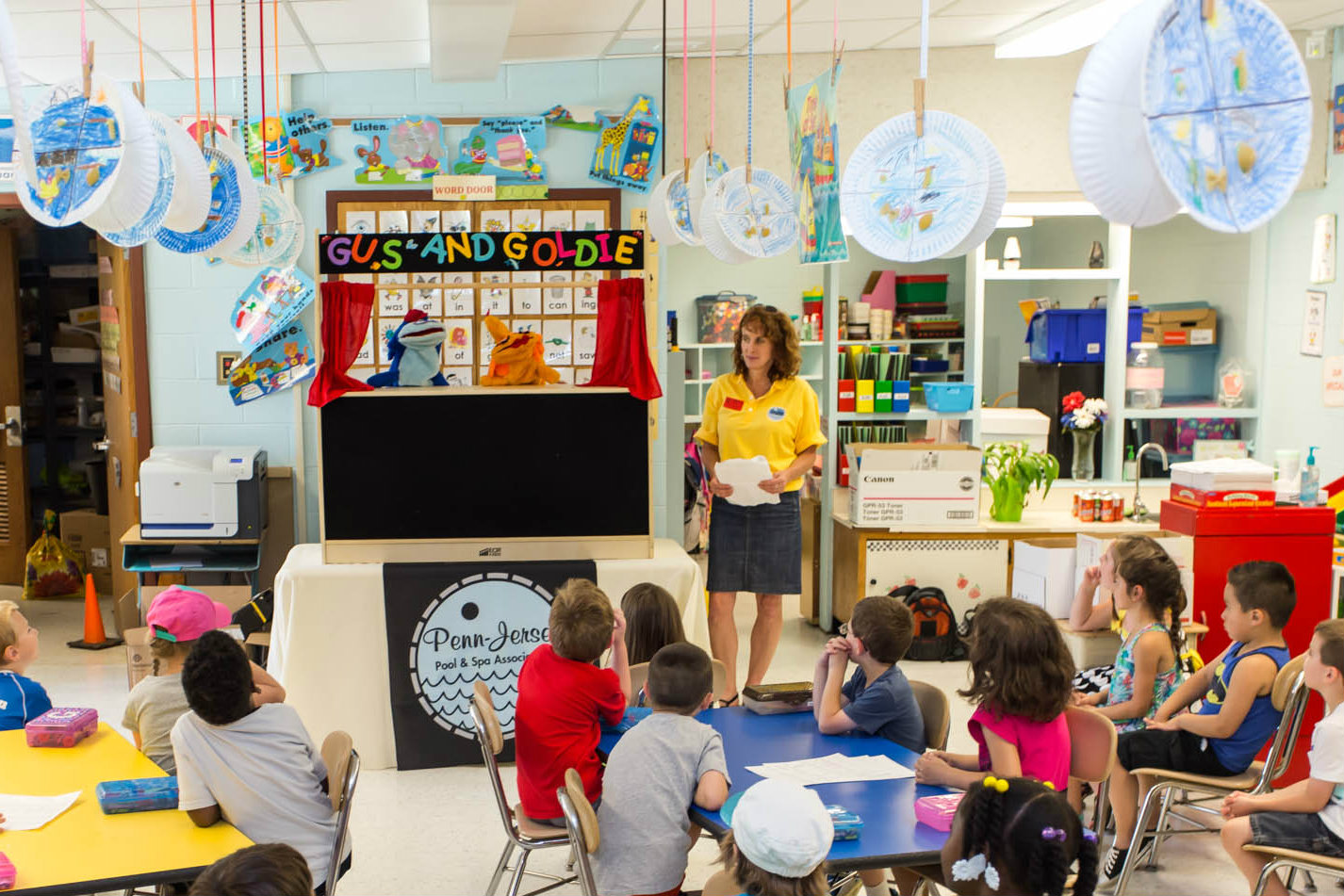 A NESPA representative presents a Gus and Goldie puppet show in 2014.