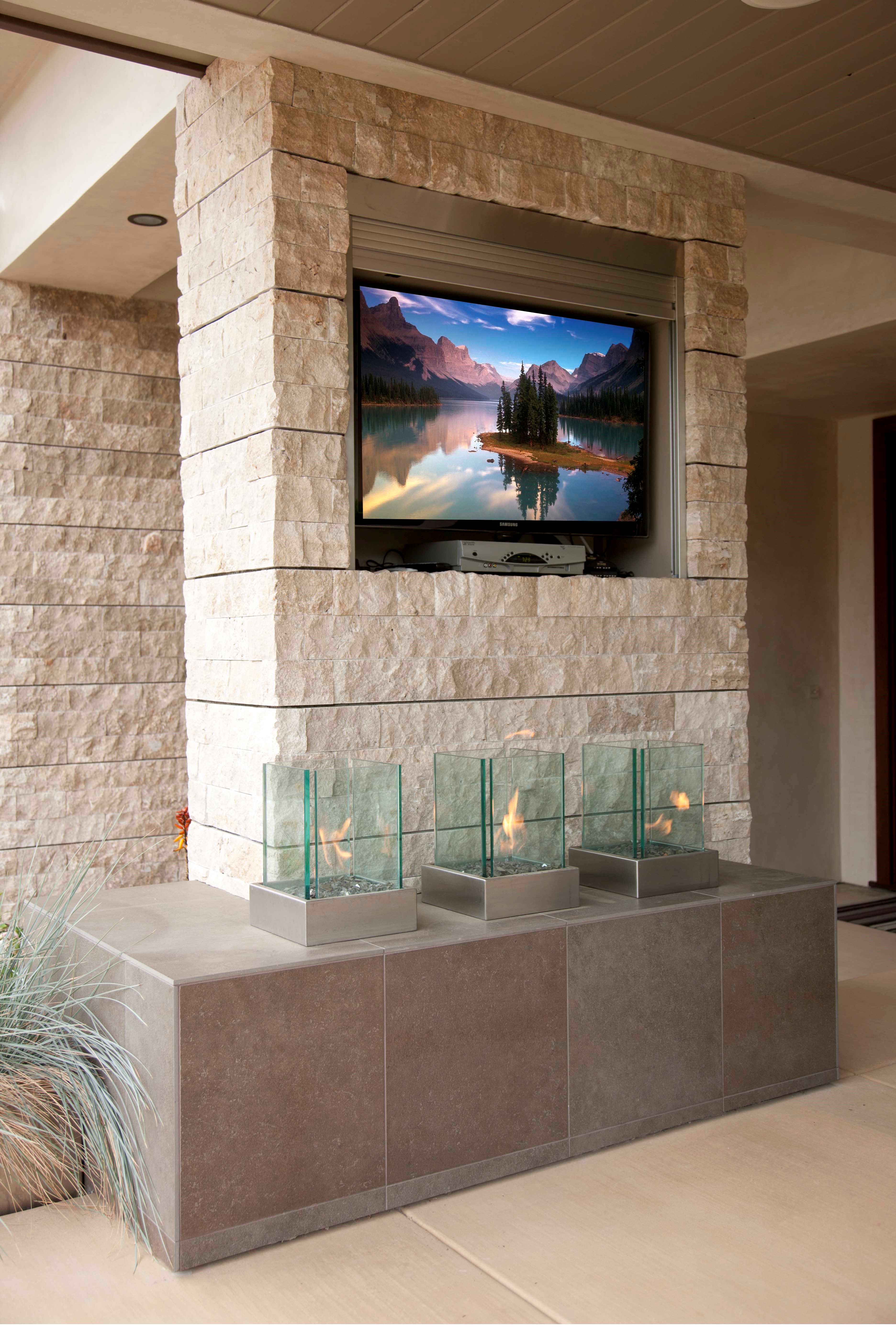 Three individual glass-enclosed flames offer ambiance and provide a balance of modernism while drawing on a natural element to create a serene escape.