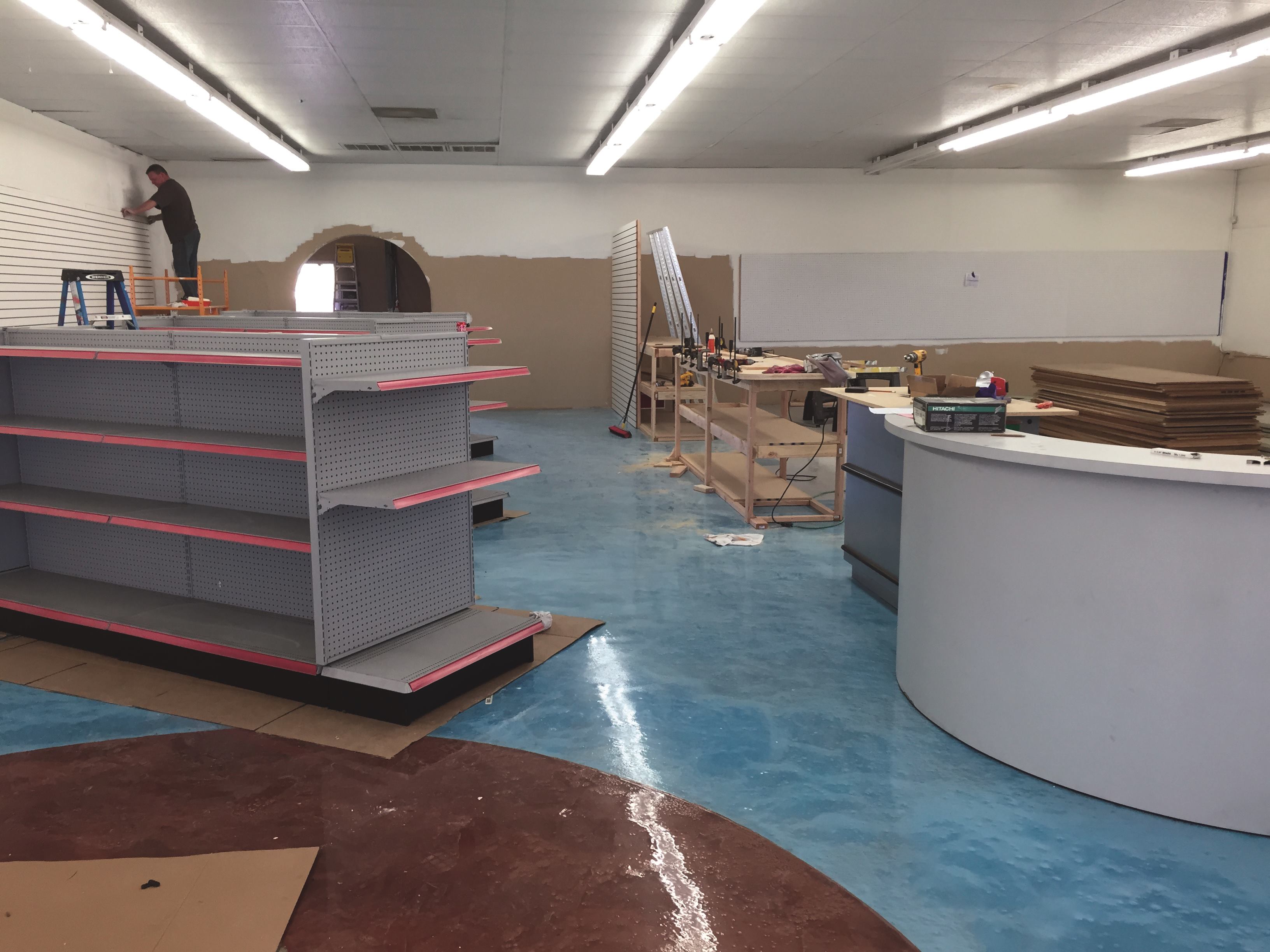 Part of the quick build including painting, installing slatwall and building displays.