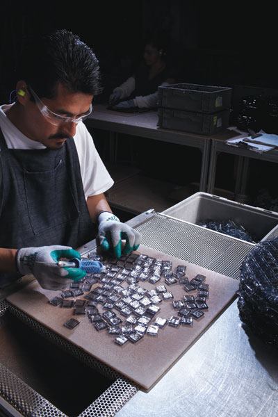 Though some professionals believe that all glass is created equal, others contend that the quality of ingredients and the manufacturing process can make all the difference. Here, a batch of cast glass tile has just been scored and tapped apart into separate pieces.