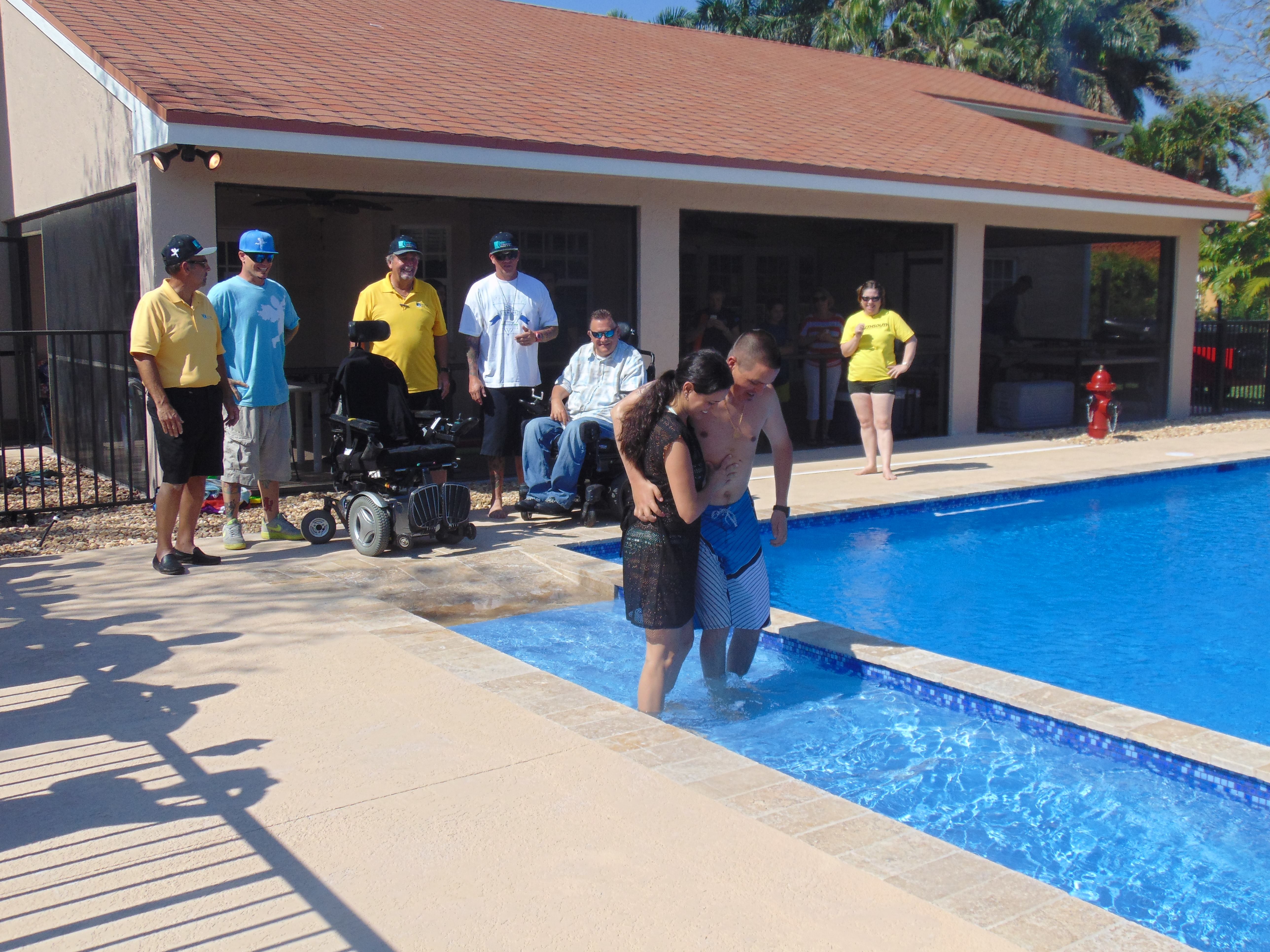 With the help of his wife, Avilez walks down the special entry ramp and into his new pool for the first time.