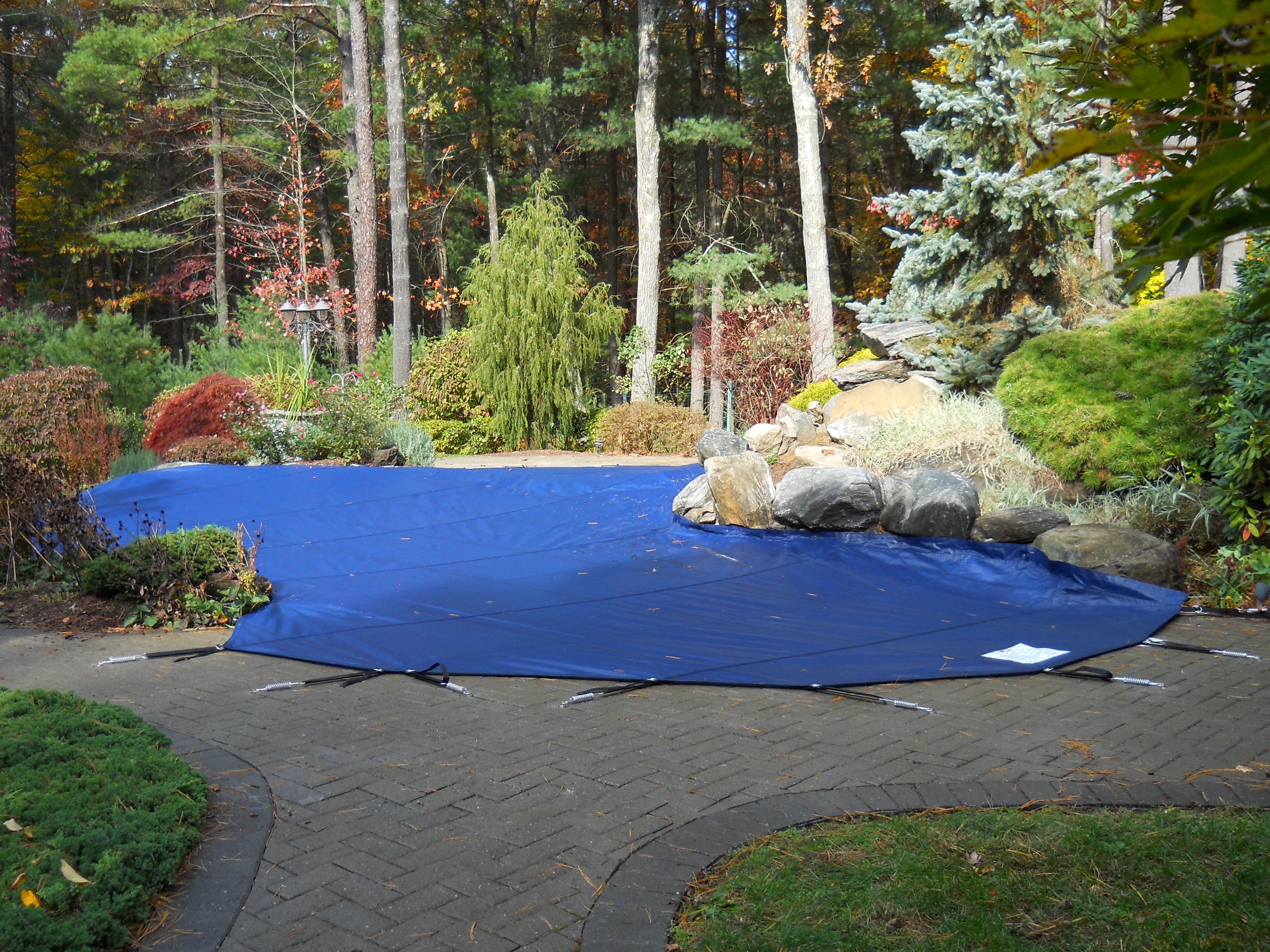 This image shows an example of a winterized pool using a safety cover.