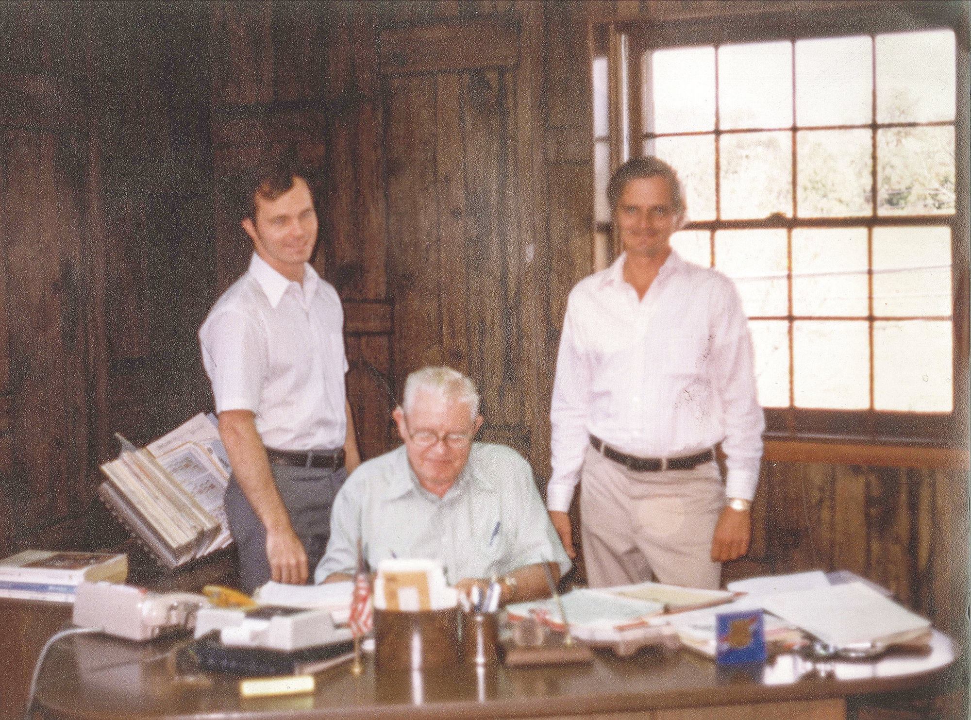 Triumphant: Since 1955, W.W. Adcock has provided distribution services from its Pennsylvania base. In this 1980 photo, founder Woodrow W. Adcock (seated) is joined by sons Dee (left) and Dale. 