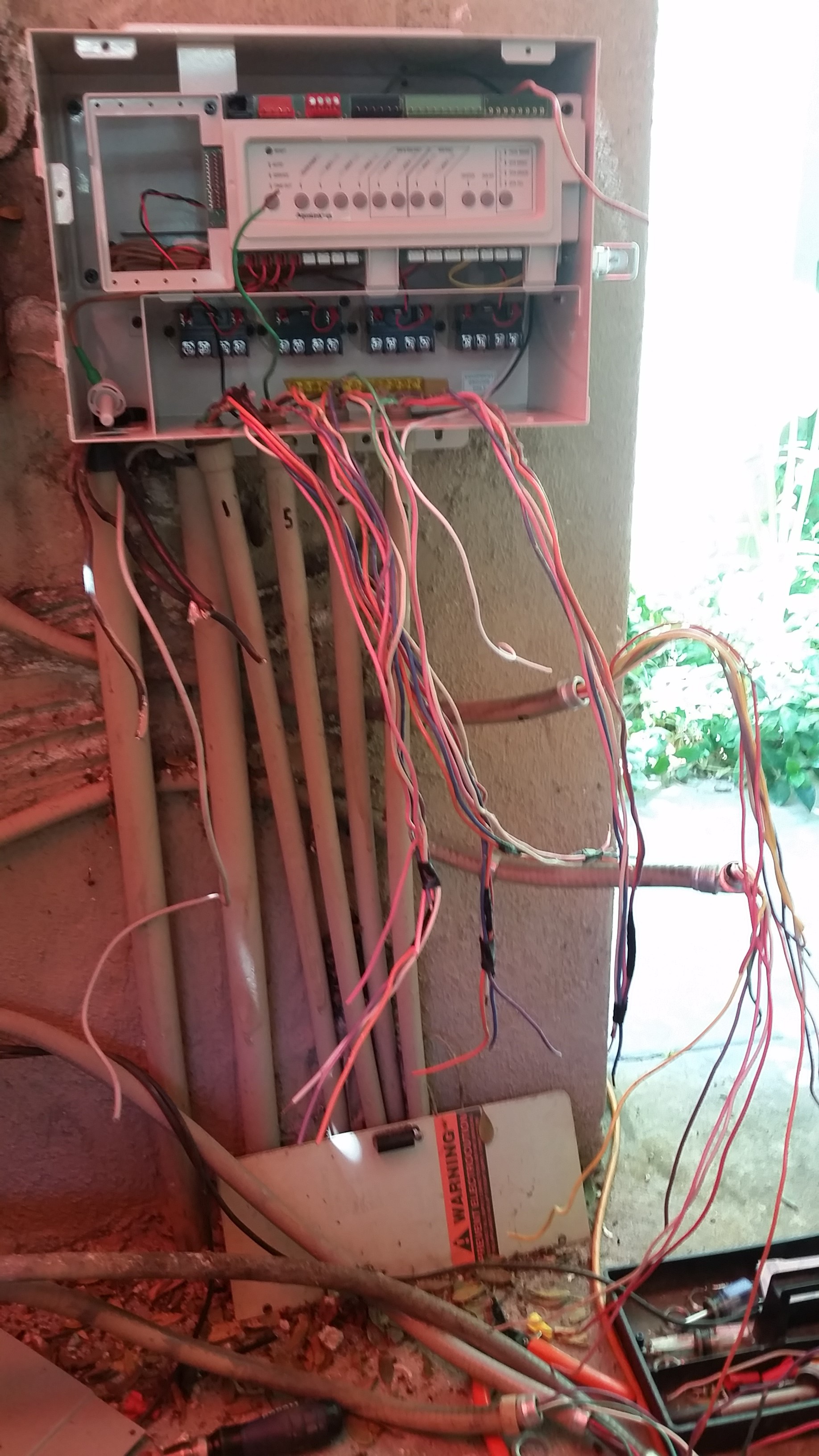 Before: This retrofit involved a crazy number of wires to reconnect to control the pool equipment and low-voltage landscaping lighting.