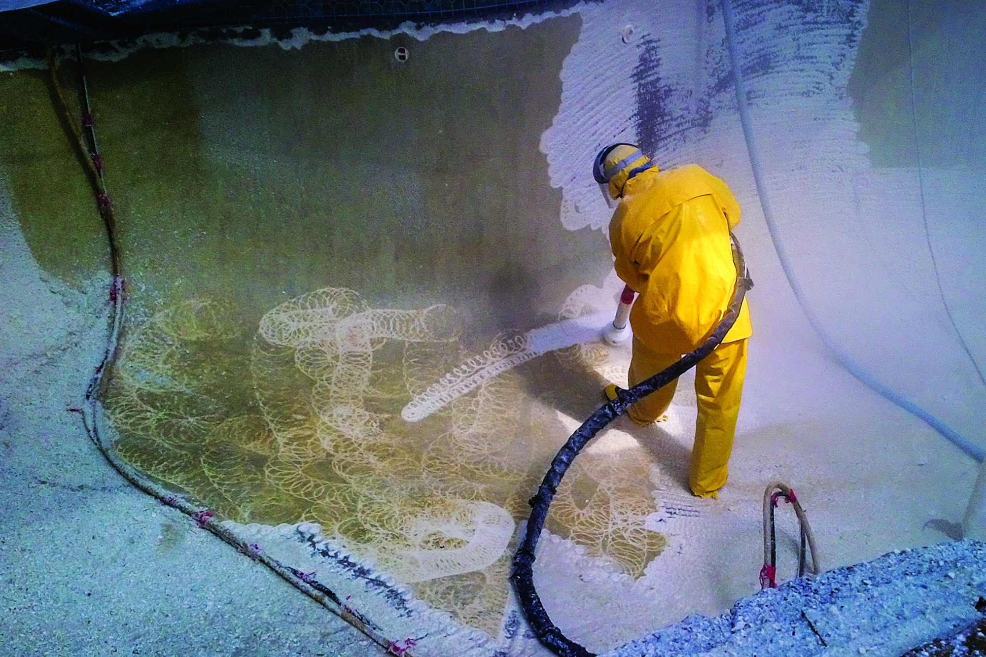 Crews gear up for safety by wearing a rain suit and head gear when they water jet.