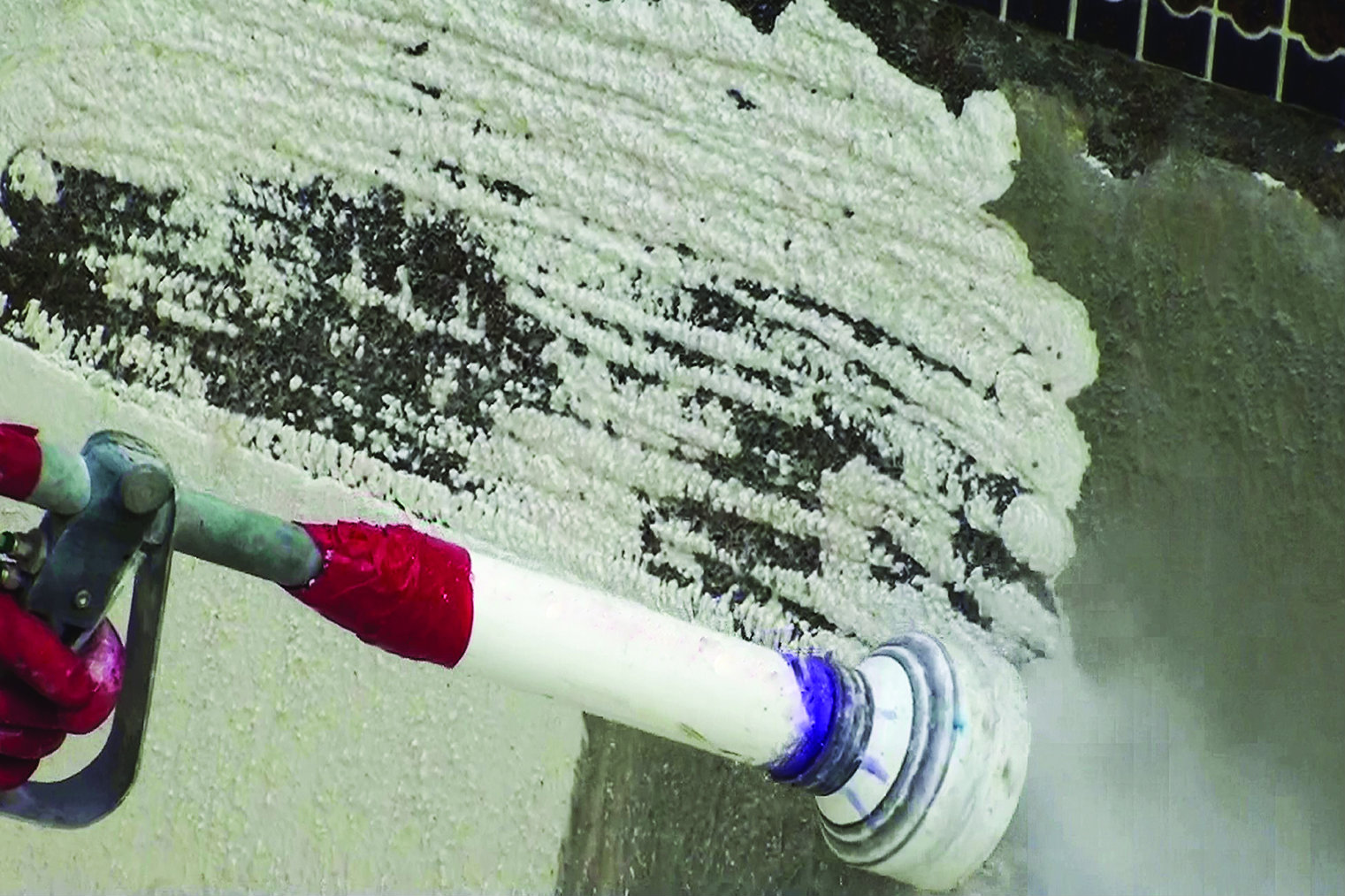 For maximum impact, the nozzle can be held perpendicular to the wall. To avoid a mess, an angle may be better.