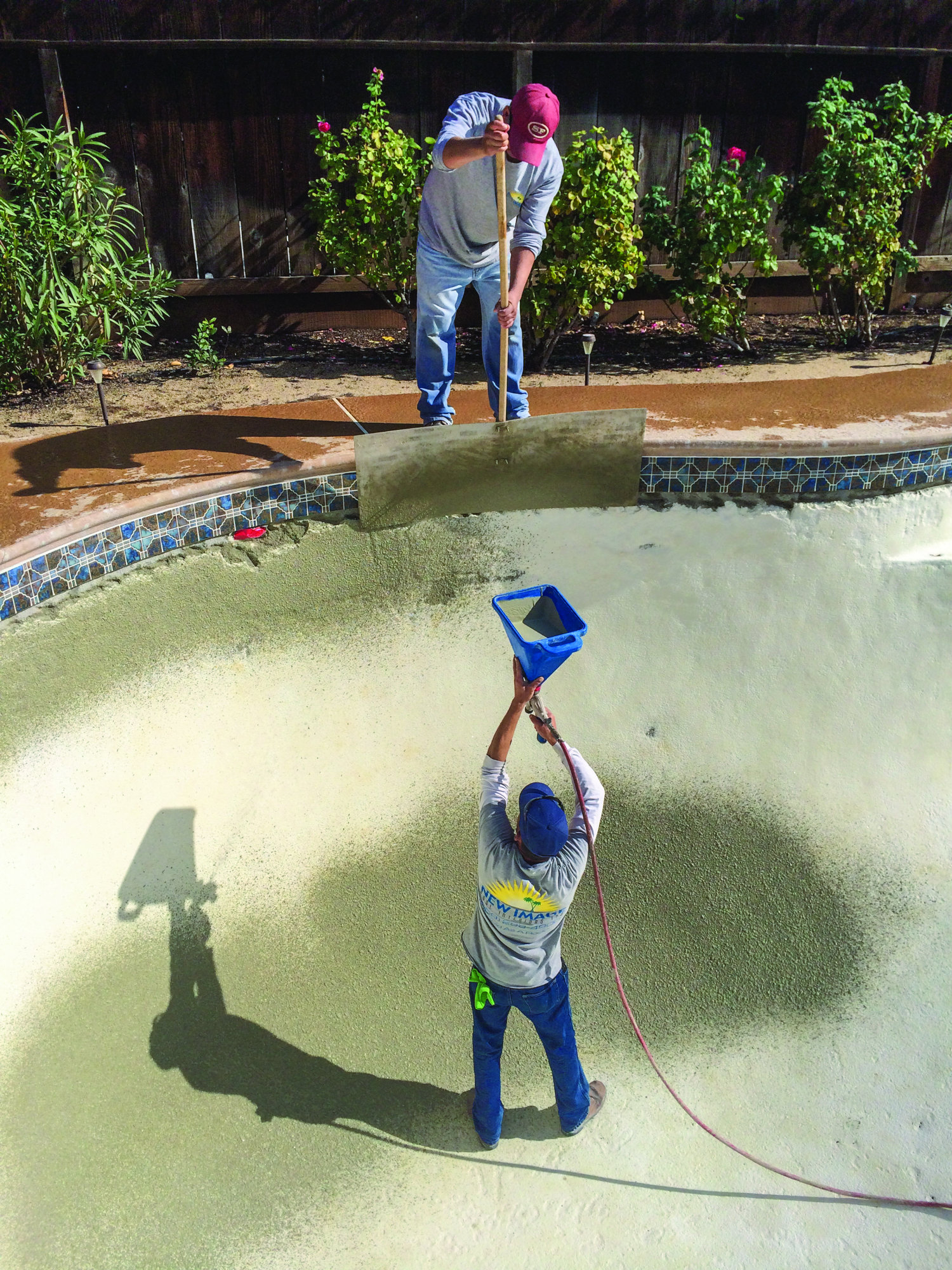 A properly adjusted spray gun can make it easier to achieve the perfect stippled texture of bond coat. A hopper gun is held perpendicular to the surface.