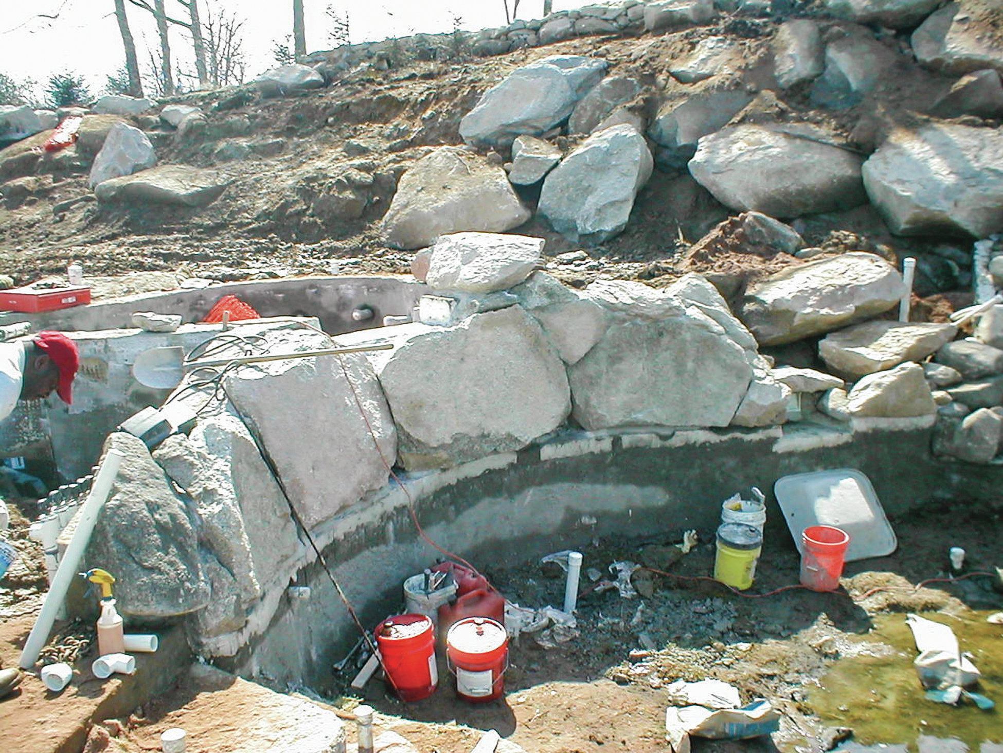 Rocks from the site set along the edge of the pool and grouted into place provide a natural transition from the spa. The gunite walls of the pool are adequately reinforced to carry the extra weight. All of the stone used in the project was excavated from the site.