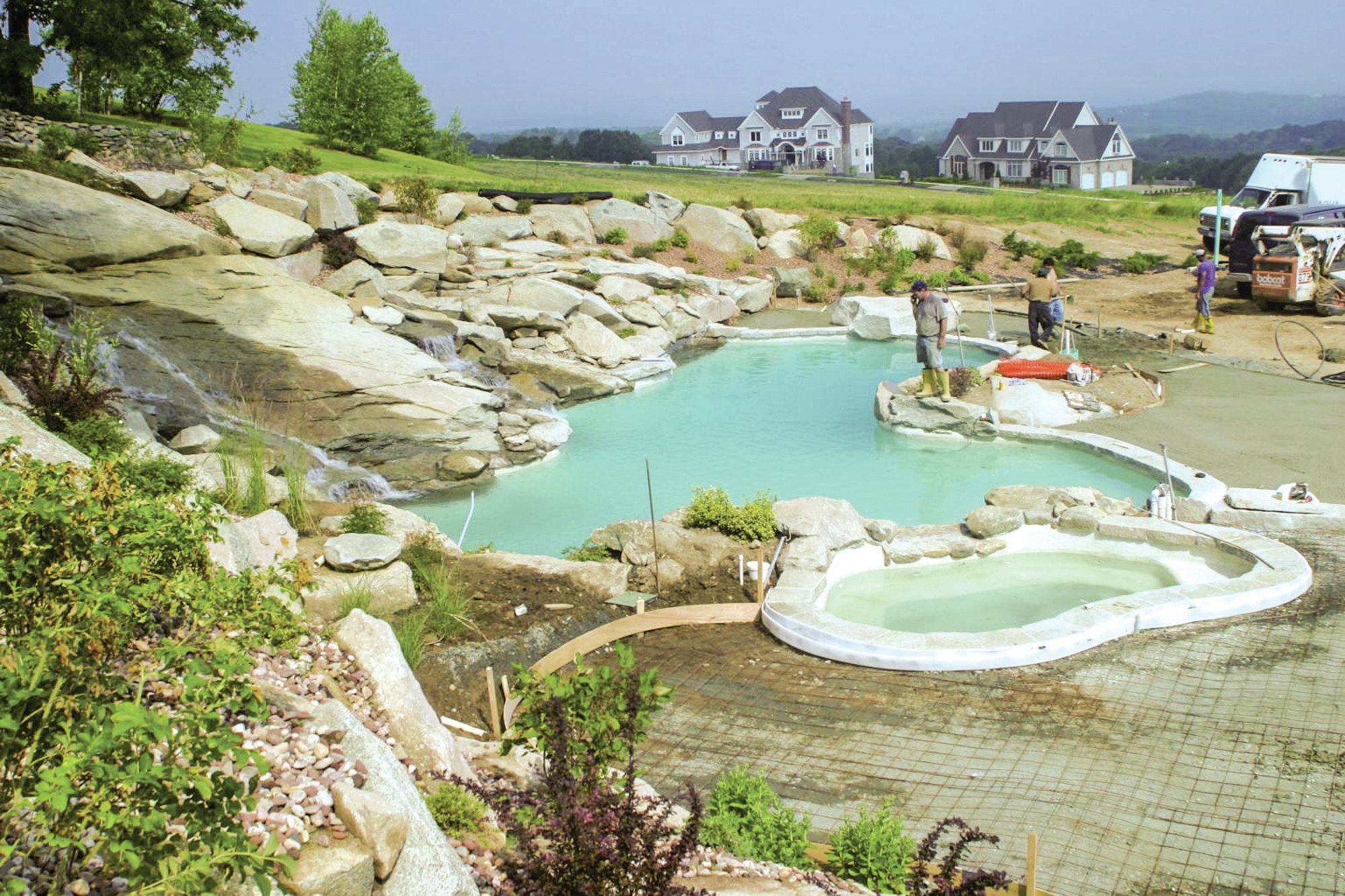 The walls of the pool were finished with Pebble Tec. Once filled, the pool’s walls disappear beneath the overhanging stone edges, creating the impression of a natural setting. “One of the things we did a little differently here is to leave the spa open year ‘round,” says Giannamore, referring to the wintry New England climate. “So we excavated deeper than normal for the recirculation lines, plus all the plumbing for the spa is protected with insulation. All the heating equipment is indoors, about 75 feet away, so the hydraulic design — in terms of flow rates and turnover — was a little more complicated than usual.”
