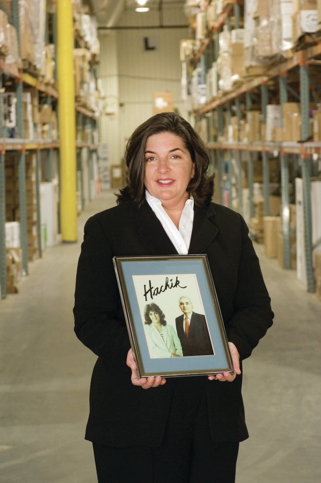 Forward thinkers: 91 years later, granddaughter Nanette Zakian (with a photo of her and her father) leads the Pennsylvania-based distributor Hachik.