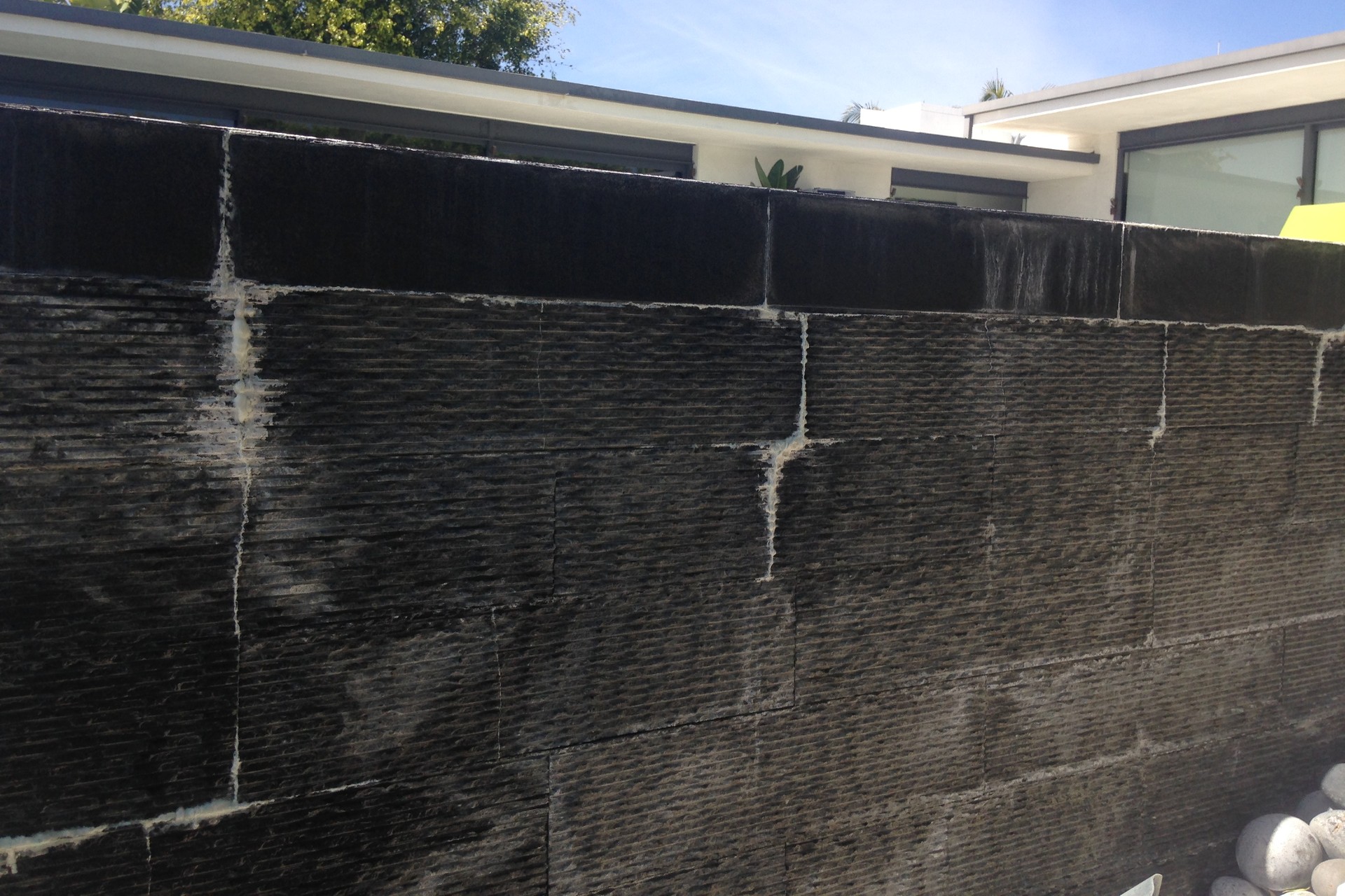 On these stone-tile installations that National Tile and Stone Authority inspected, latex has re-emulsified through the grout, likely due to inadequate curing times for the thinset.