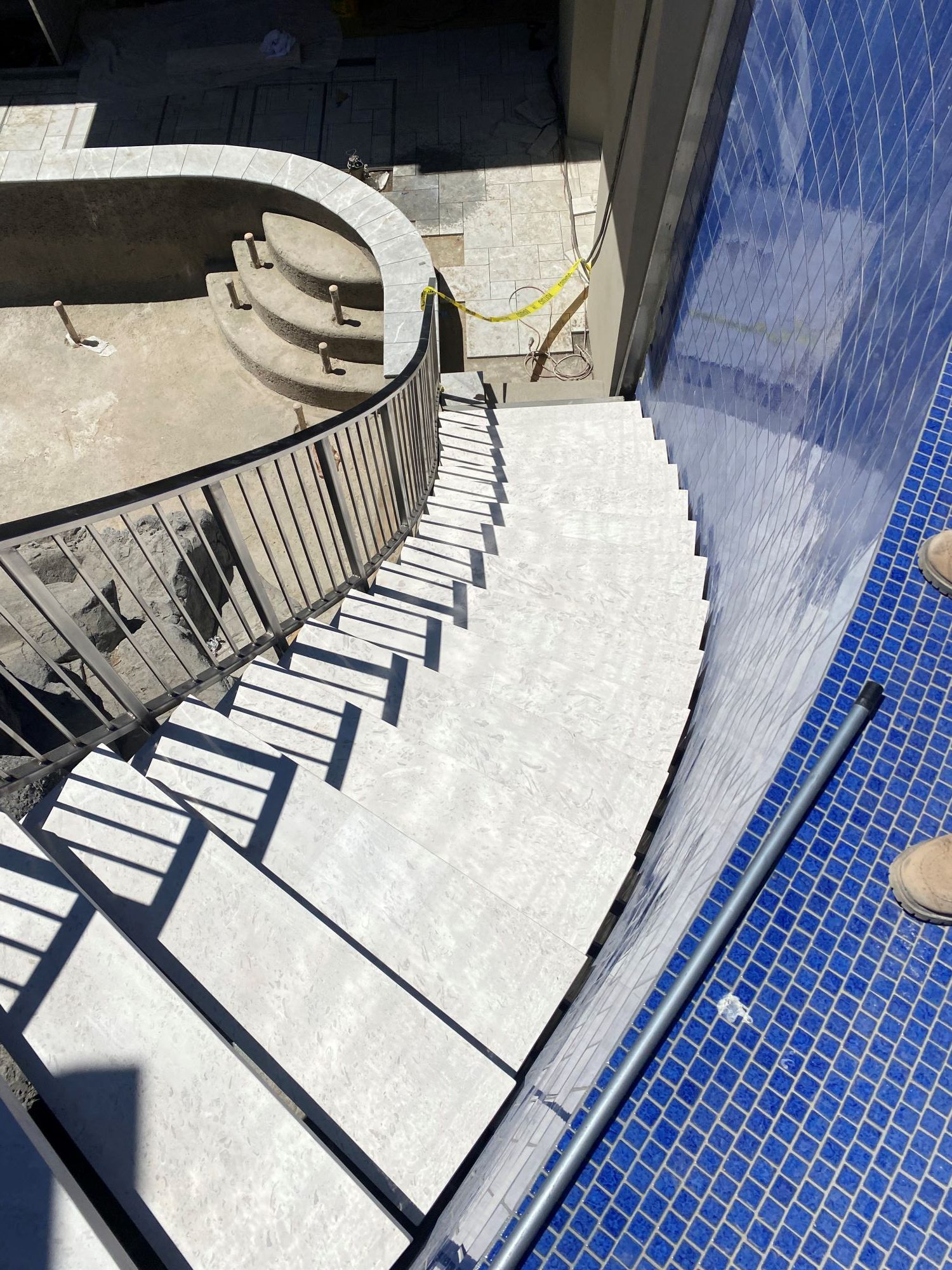 A stairway leading from the main-pool level down to the lower pool.