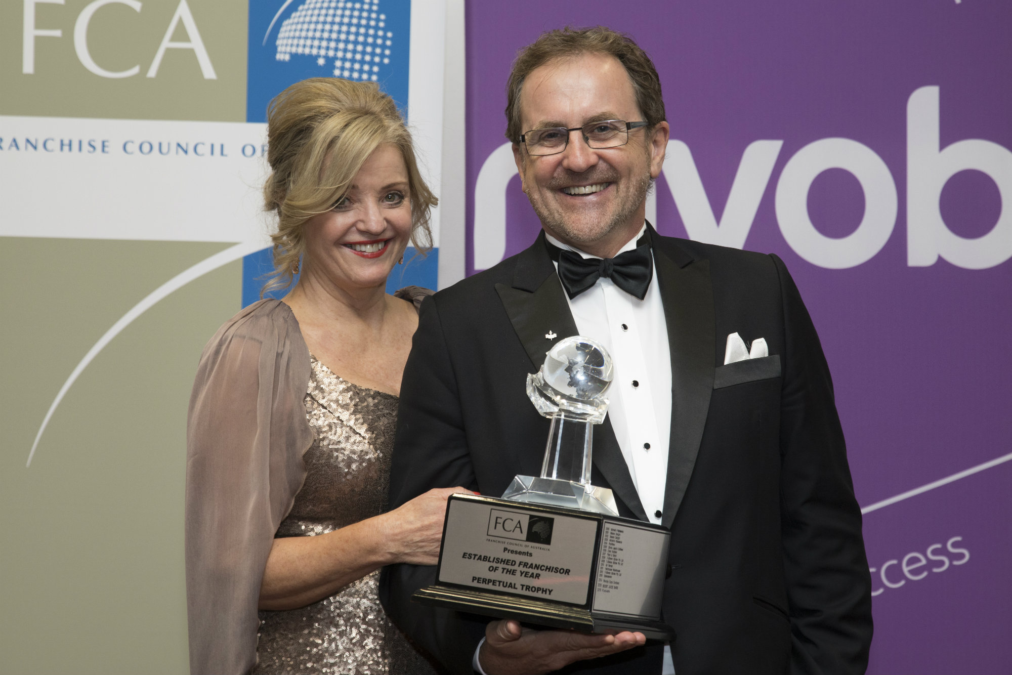 Poolwerx CEO John O'Brien and his wife, Helen, with the "Established Franchiser of the Year" award from the Franchise Council of Australia.