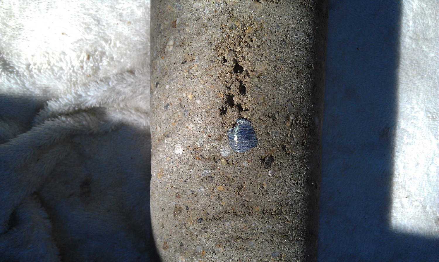 These photos show shadowing, in which shotcrete fails to properly 
compact behind the rebar. Here the concrete is not monolithic in the 
space behind the steel.