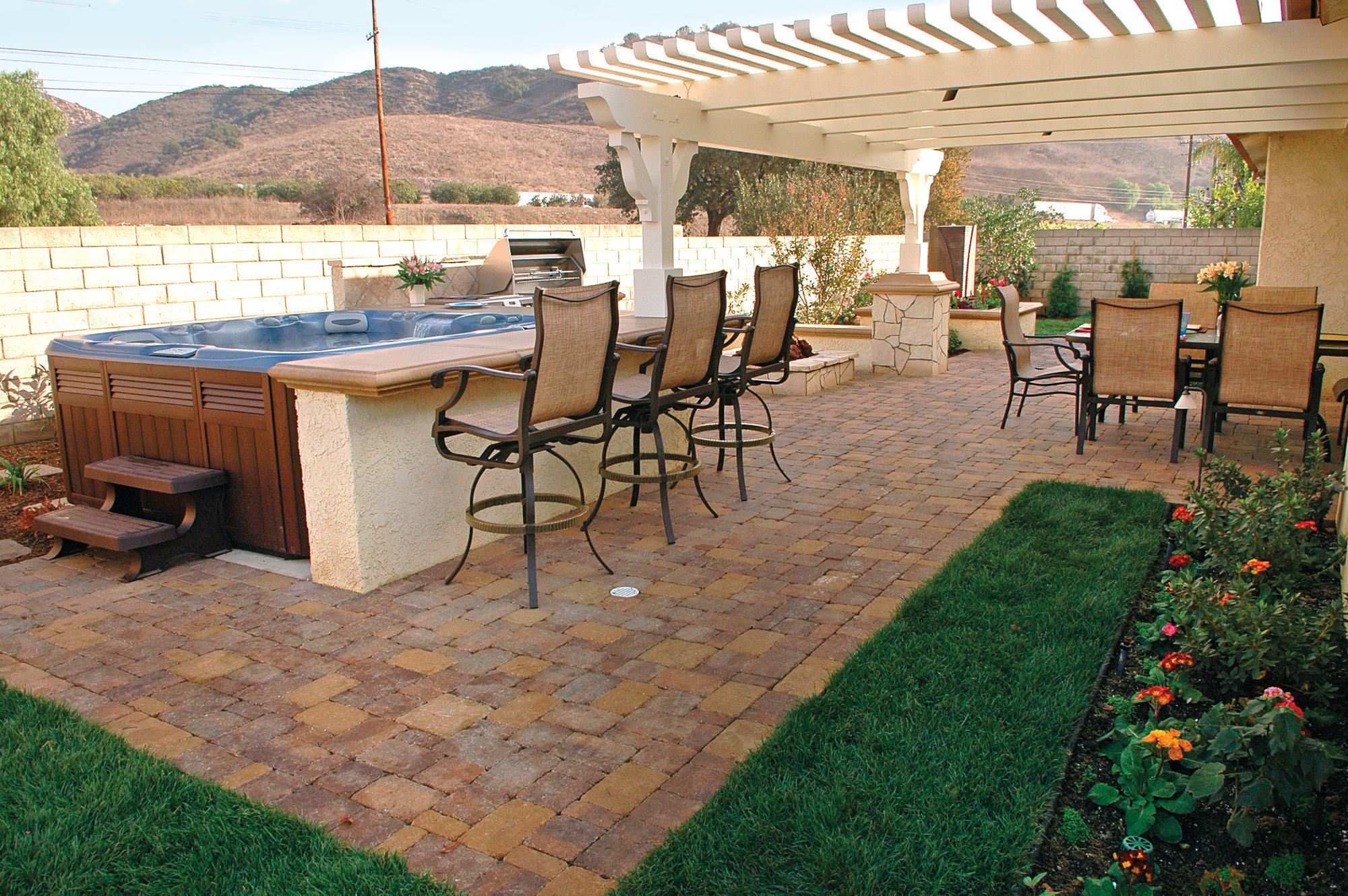 Appealing to the senses: Not all homeowners want a shade structure over their spa. Some like to stargaze, making it better to leave the spa unshaded. A counter and seating around the hot tub encourages conversation.