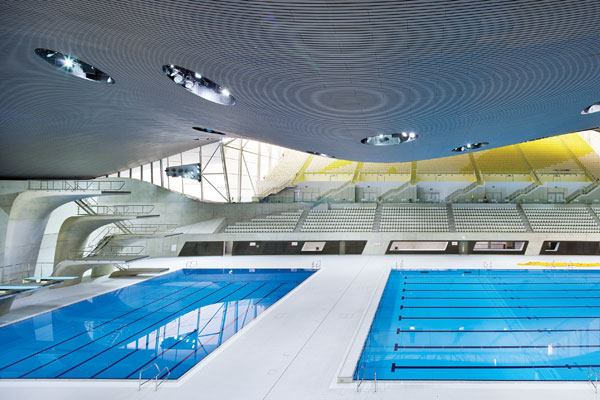 Design DetailsLike its predecessor the Water Cube, the London Aquatic Centre is designed with an eye toward aquatics and the fluidity of water in motion, but it avoids cliché. Sulfur yellow, one of the official London 2012 brand colors, was used to accent the gray stain applied to the building to give it a consistent, weathered-finish look. Succumbing to using the blue associated with pools would have been too obvious, says the designer.