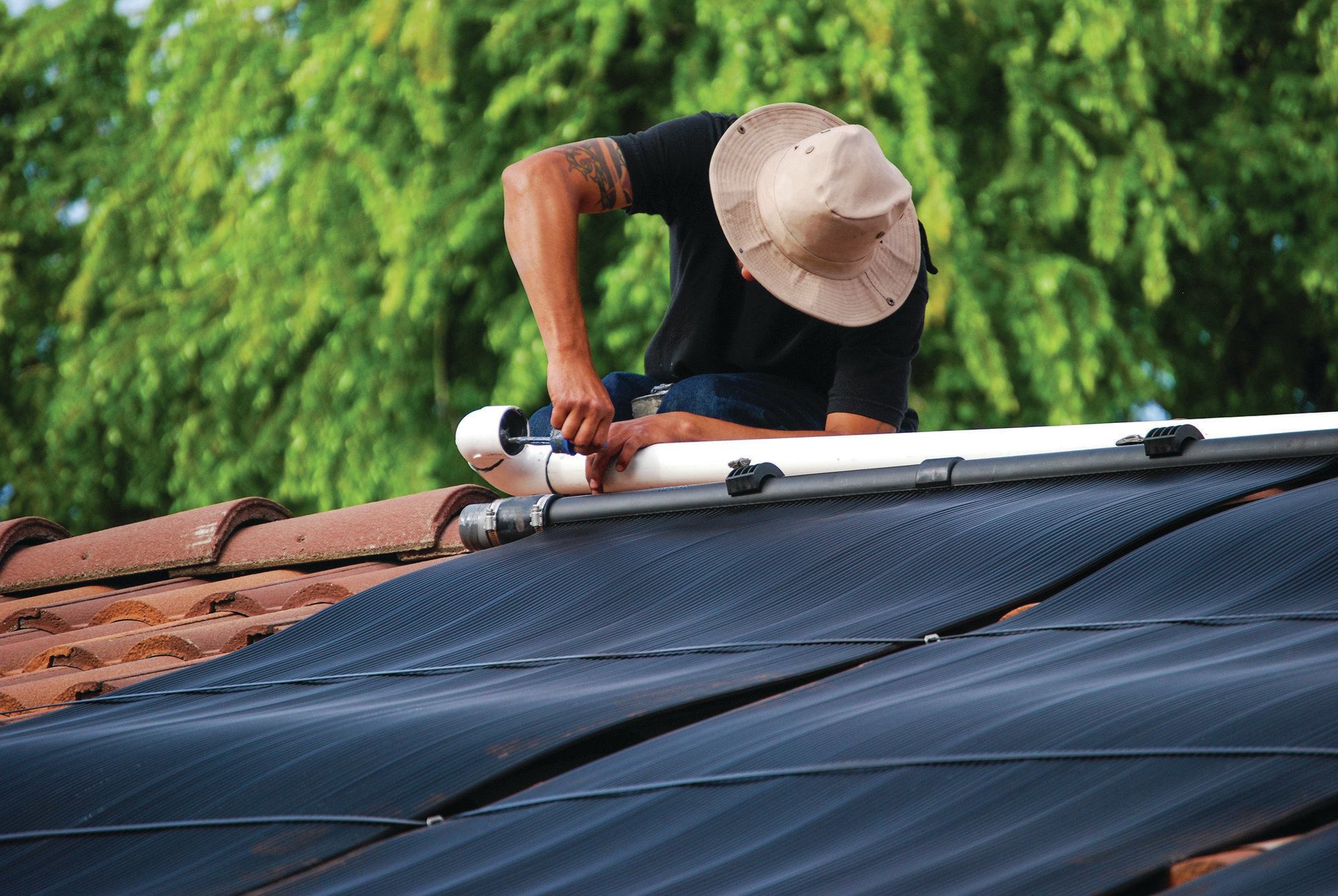 7) Meanwhile, the return line is fitted to the top of the collectors. When the collectors are operating, water from the pool will come into the collectors from the bottom and be heated as it rises through. It will then be returned to the pool.