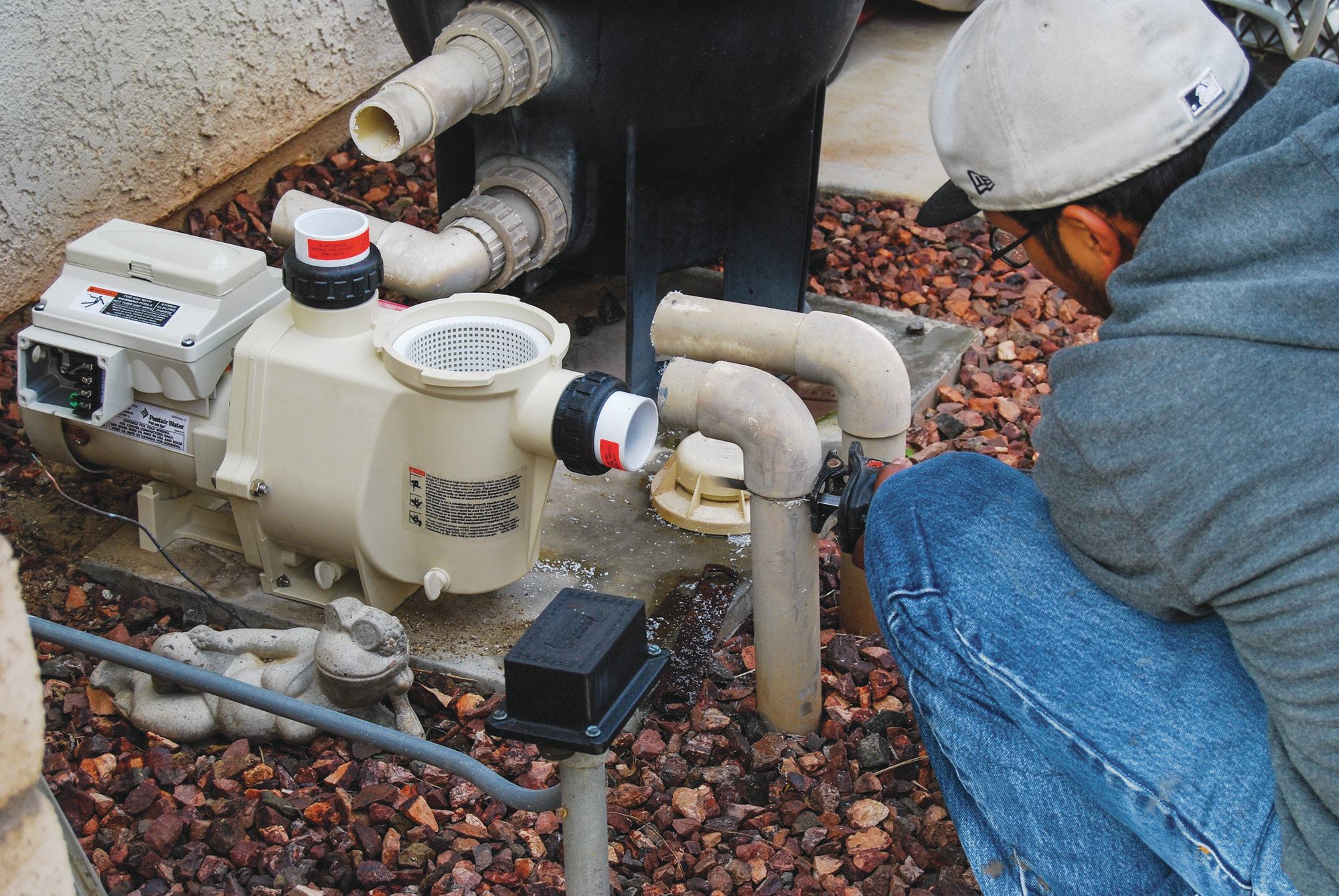 6) The old single-speed pump is removed and a new variable-speed model is prepared for installation. Afterwards, a sensor will go into the line to test the water temperature from the pool. Another sensor checks the roof temperature. A four- to seven-degree differential activates the system.