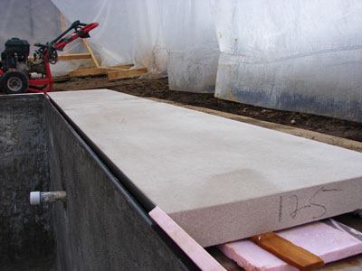 “Lautner” Knife Edge: The French limestone coping (top) is set to create a 1-inch slot between it and the black absolute granite tile that angles down into the perimeter gutter.  316 marine grade stainless steel (bottom, left) is cantilevered over the perimeter gutter to support the limestone coping. Stainless steel is treated with Sikadur’s Sika 32 Hi-Mod to enable the setting materials and limestone to bond to it.  An all-glass tile slot-overflow pool designed by Aquatic

Consultants (bottom, right) and built by Aquaknot Pools in Weymouth, Mass., shows the drama and beauty created by a deck-level pool.