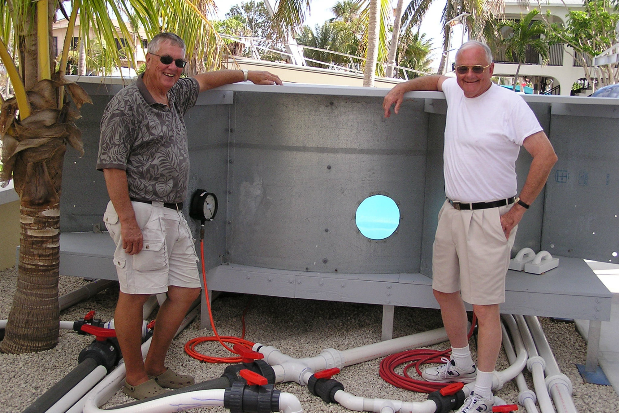 Don Witte (left), with frequent collaborator William Rowley at a test pool built on Witte's property.