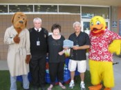Building awareness: McGruff the Crime Fighting Dog and Tim Szymanski,
 Las Vegas Fire and Rescue Public Education & Information Officer, 
assist Lois Tarkanian, City Councilwoman, in presenting Joseph Vassallo,
 president of Paragon Pools, and Duckie, the Float Like A Duck mascot, 
with the 2014 National Drowning Prevention Alliance Community Lifesaver 
Award. The presentation was made on behalf of the NDPA during Vassallo’s
 annual water safety event on May 24 at the YMCA in Las Vegas.