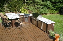 Clarksburg

 This outdoor space is a homeowners dream! With so much to do, the homeowners and their guests can enjoy this deck space for hours at a time. Completed in April of this year, the deck itself is constructed with composite decking. The glass railing infill provides an illusion that that deck never ends. The deck features several different living areas. The aluminum shade structure provides protection from the sun and elements. Granite countertops and stone veneer accent the top of the line stainless steel appliances. 
        On cool summer nights, the homeowners can cozy up next to the custom fireplace, which is surrounded with plenty of seating. It is easy to relax in this outdoor space as this deck also features a built in spa.