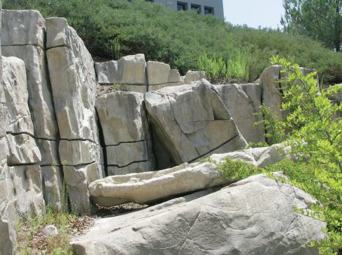 Best practices: Rock formations evolve over time and the most realistic non-natural installations reflect this. Here, a large piece appears to have split from the main formation and fallen to the ground.